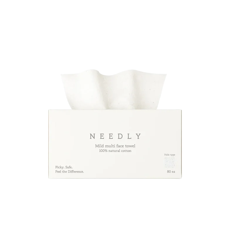 Kutija papirnatih ručnika Needly s natpisom 'Mild multi face towel' ukazuje na proizvod iz divote cosmetics linije, koji se ističe kao dio korejske kozmetike, izrađen od 100% prirodnog pamuka.