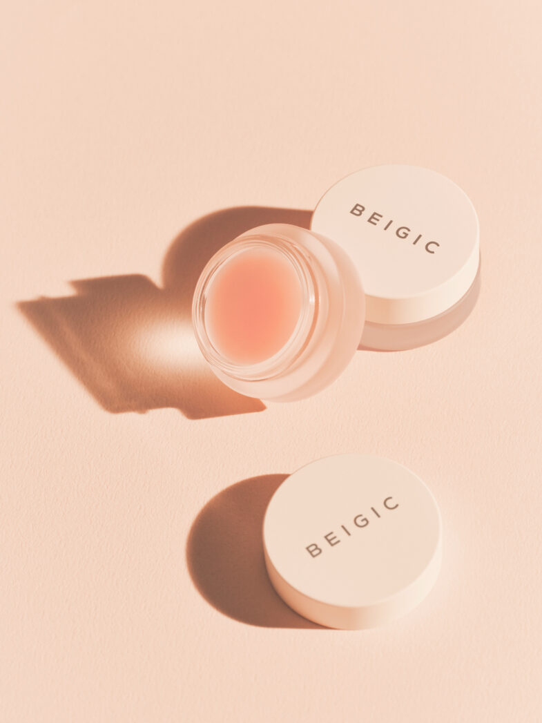 Proizvod korejske kozmetike Beigic s otvorenom i zatvorenom posudicom, u delikatnoj nijansi ružičaste, promovira brend Divote Cosmetics.